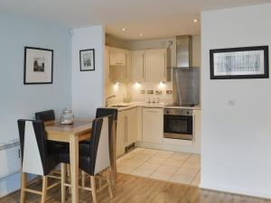 a kitchen and dining room with a table and chairs at Number 7 in Whitby