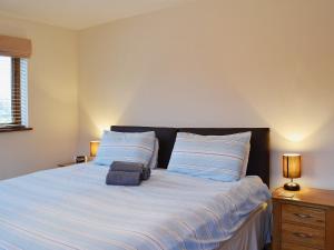 a bedroom with a large bed with two pillows at Stables - 24734 in Bearsted