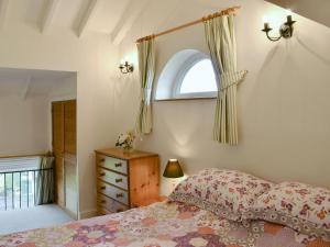 a bedroom with a bed and a window and a dresser at Orchard Chapel in Much Marcle