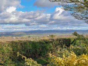 a view of a field with mountains in the distance at Orchard Chapel in Much Marcle