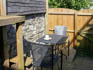 a black table and chairs with a cup of coffee on it at Glaramara in Kendal