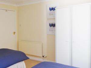 a bedroom with a bed and a large sliding door at Avalon in Grainthorpe