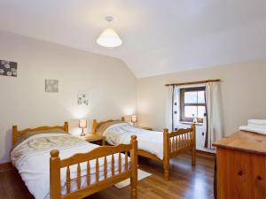 1 dormitorio con 2 camas y ventana en The Cottage - 28645 en Alston