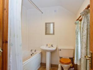 a bathroom with a sink and a toilet and a bath tub at The Cottage - 28645 in Alston