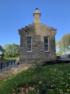 a stone building on top of a grassy hill at Station House in Durham