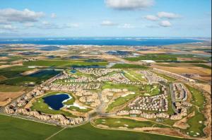 an aerial view of a golf resort with a lake at Spacious luxe apartment on Mar Menor Golf Resort with Padel, Fitness, Wellness facilities in Torre-Pacheco