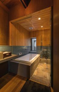 a large bathroom with a tub and a shower at Hitoiki in Nagahama
