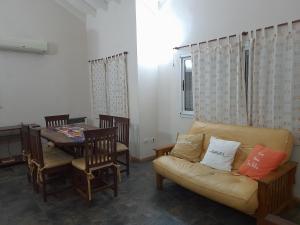 a living room with a couch and a table at Casa Naranja in Merlo