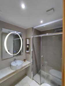 a bathroom with a shower and a sink and a mirror at LOTUS HOTEL Casanearshore in Casablanca