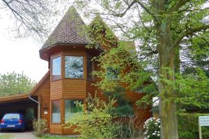 a wooden house with a window and a tree at An-Hog-Barg-1 in Godern
