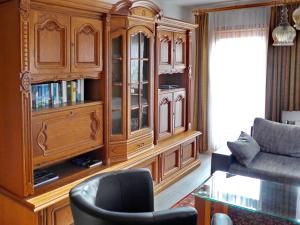 a living room with a large wooden hutch at An-Hog-Barg-1 in Godern