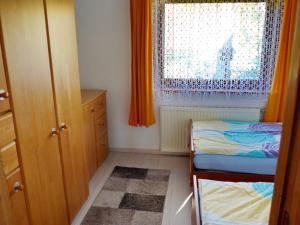 a small bedroom with two beds and a window at An-Hog-Barg-1 in Godern