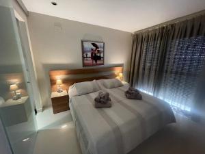 a bedroom with a bed with two towels on it at Apartment Vista Bella in Calpe