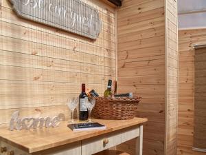 a table with wine glasses and a basket on it at Leighwood in Sandwich