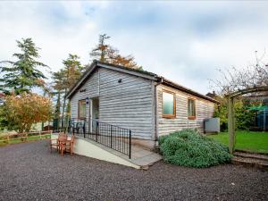 a small house with a staircase leading to it at Challette At Timbertops in Washfield