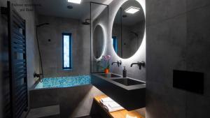 a bathroom with a sink and a mirror at Apartments Reykjavik in Reykjavík +68 photos