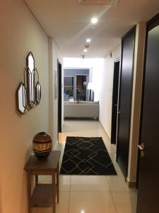 a hallway with a table and a room with a bathroom at Downtown Boulevard one bedroom Apt in 29 blvd غرفة وصالة Burj & fountain View Master bedroom plus 2 single beds in living room in Dubai