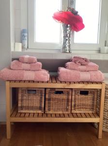 een kamer met een tafel met roze handdoeken en manden bij Corte Da Vinci - Fiera Milano e Milano City in Bareggio