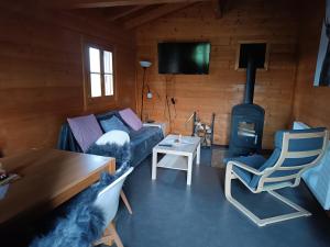 a living room with a couch and a wood stove at Holzhaus Fechheim in Neustadt bei Coburg