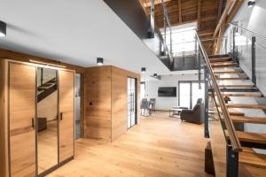 an open hallway with wooden floors and a staircase at Chalet-Ferienwohnung Bergloft, 115 qm, Wellness/Fitness/Sauna – Bergrödelhof in Feilitzsch