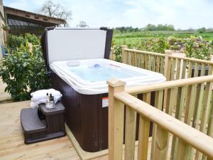 a hot tub on a deck with a sink at Sykelands Cottage in Ravensworth