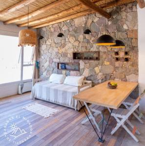 1 dormitorio con cama y mesa de madera en Cabañas El Mirador de Tilcara en Tilcara