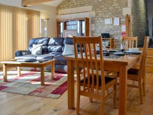 a living room with a table and a couch at Stratton Mill in Cirencester