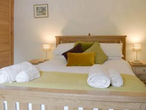 a bedroom with a large bed with towels on it at The Oak in Newchurch