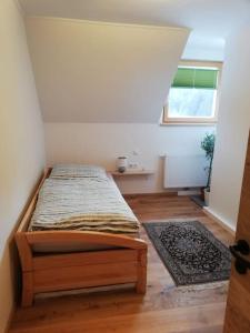 um quarto com uma cama num quarto com uma janela em Ferienwohnung Eisenerz 80m² em Eisenerz