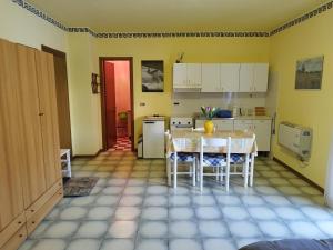 een keuken met een tafel en stoelen in een kamer bij Appartamento Germano - Regina delle Alpi in Preinardo