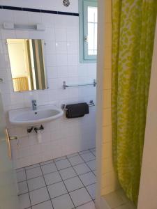 a bathroom with a sink and a mirror at Les lauriers in Moissac-Bellevue