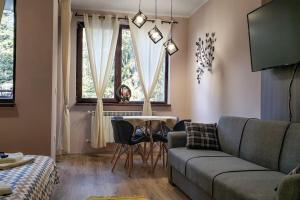 a living room with a couch and a table at BoroHome in Borovets