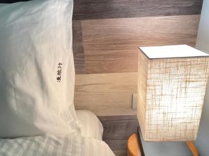 A bed or beds in a room at Ramble Travel Homestay