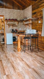 uma cozinha com mesa e cadeiras num quarto em Cabana Furna dos Pôneis em Urubici