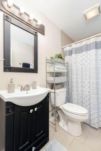 a bathroom with a sink and a toilet and a mirror at Bexley Breeze, Fast Wi-Fi, King Bed in Bexley