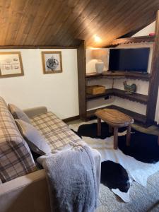 a living room with a couch and a table at Casa Gran Paradiso in Cogne