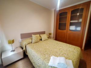 małą sypialnię z łóżkiem i drzwiami w obiekcie Casa Abeleira w mieście Arzúa