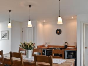 a kitchen and dining room with a table and chairs at 7 Greep in Orbost