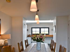 a dining room and kitchen with a table and chairs at 7 Greep in Orbost