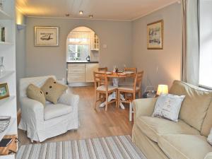 a living room with a couch and a table at The Little House in Chacewater