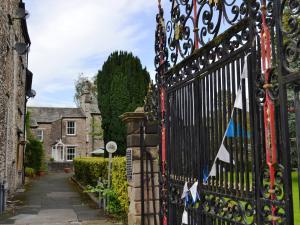 an ornate iron gate in front of a house at Church Walk Cottage in Kendal