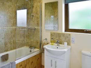 a bathroom with a sink and a shower at Willow Lodge in Burgh le Marsh