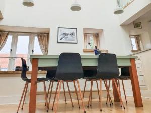 a kitchen with a table and four chairs at Madeleines Barn in Wells next the Sea