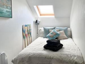 a bedroom with a bed with a window at Seascape in New Quay