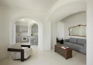 a living room with a couch and a table at Inspire Santorini Luxury Villas in Fira