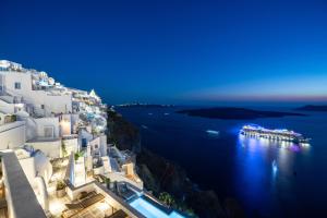 a view of the amalfi coast at night at Inspire Santorini Luxury Villas in Fira