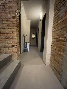 an empty hallway with a brick wall and stairs at Hıdırlık Boutique Hotel in Antalya
