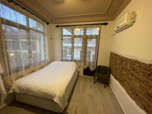 1 dormitorio con cama y pared de ladrillo en Hıdırlık Boutique Hotel, en Antalya