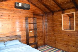 A bed or beds in a room at Shanty beach camp suer