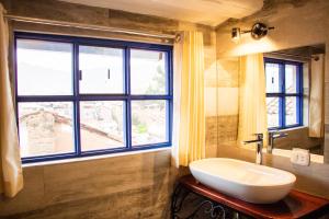 a bathroom with a sink and a large window at Auka Boutique San Blas in Cusco +158 photos